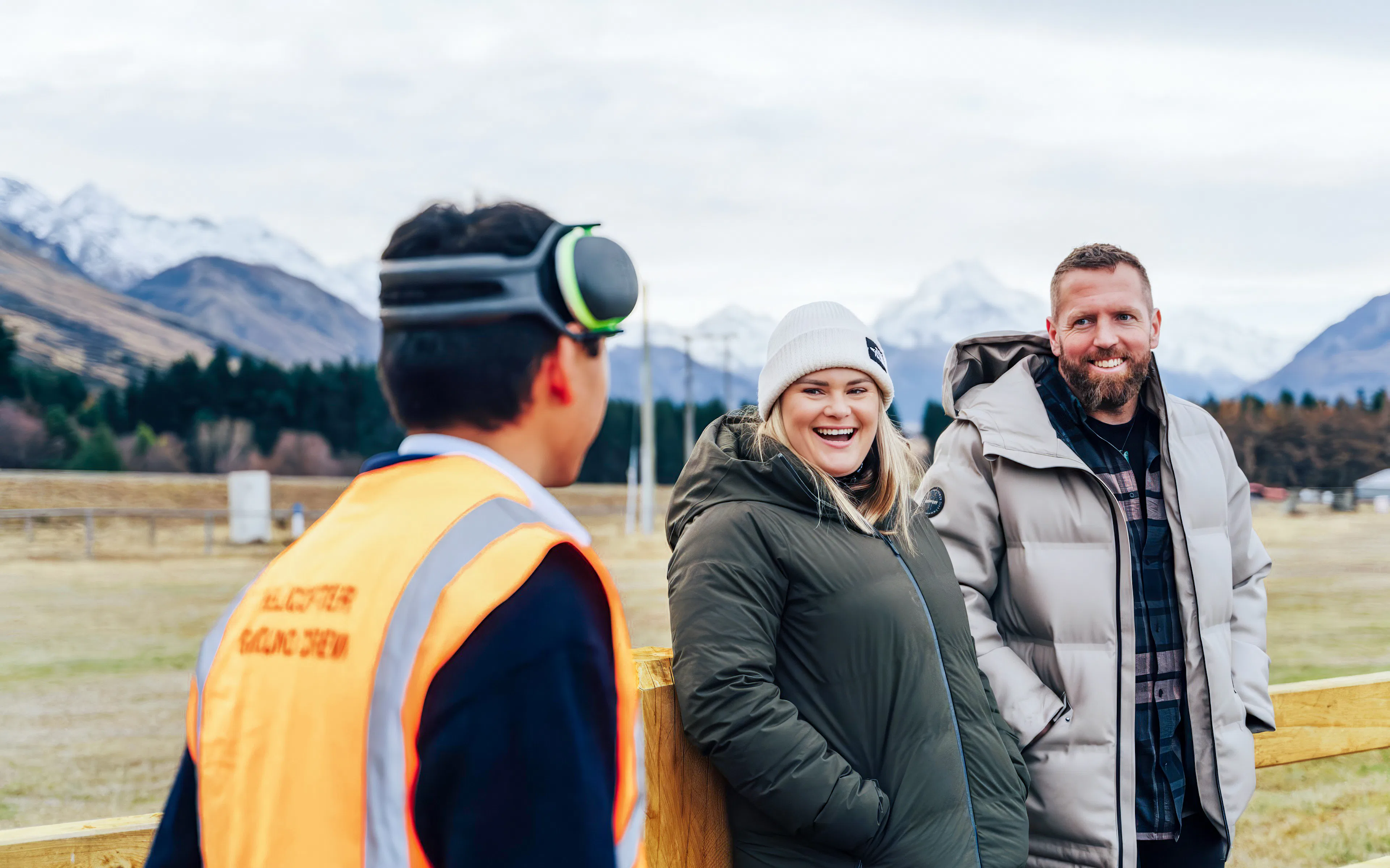 Tourists receiving a safety briefing on flight procedures in a mountainous area.