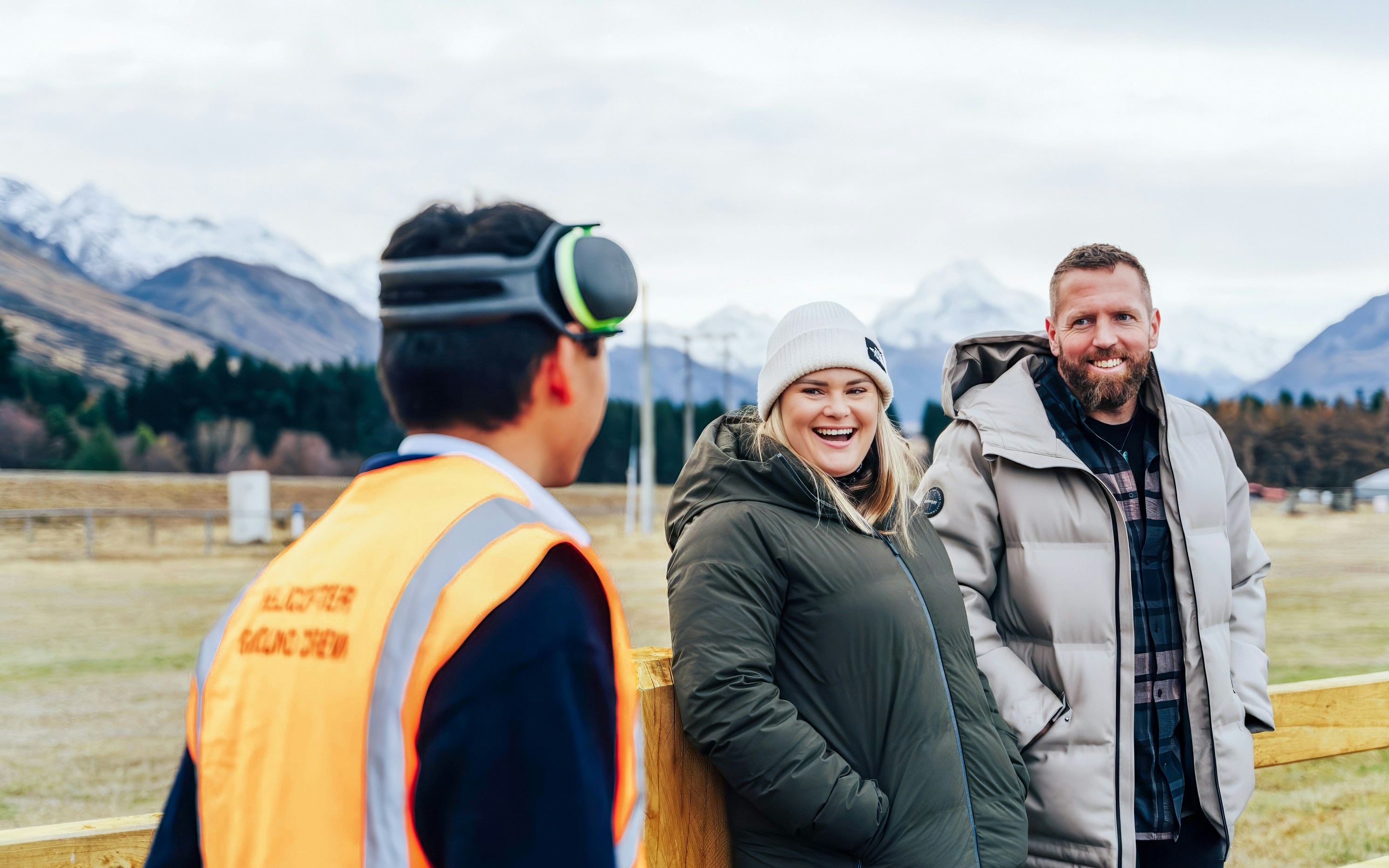 Tourists receiving a safety briefing on flight procedures in a mountainous area.