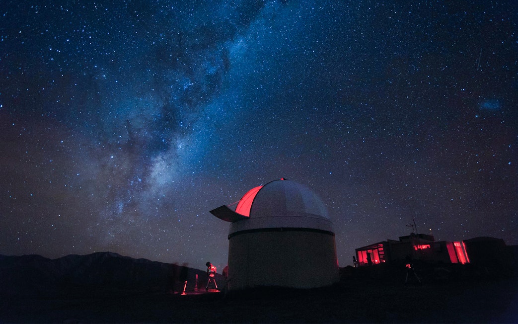 Stargazing at Mt. John Observatory under a starry sky, New Zealand.