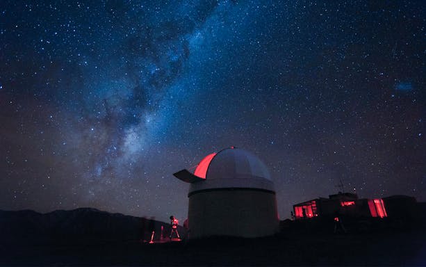 Stargazing at Mt. John Observatory under a starry sky, New Zealand.