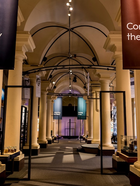 Stockholm museum exhibit with banners "Feeding Humanity" and "Connecting the World" in a columned hall.