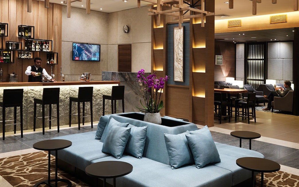 Plaza Premium Lounge bar area with seating at London Heathrow Airport.