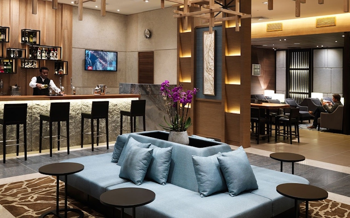 Plaza Premium Lounge bar area with seating at London Heathrow Airport.