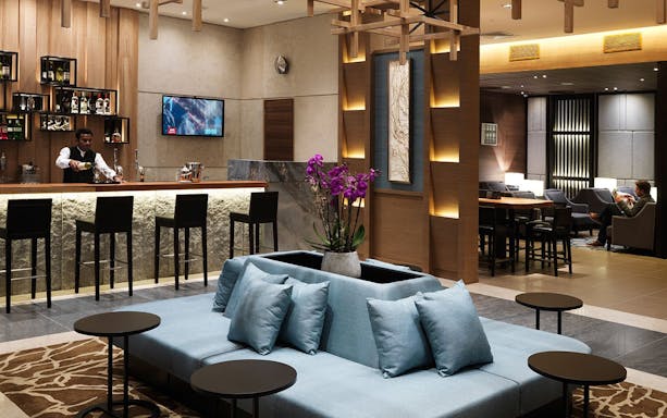 Plaza Premium Lounge bar area with seating at London Heathrow Airport.