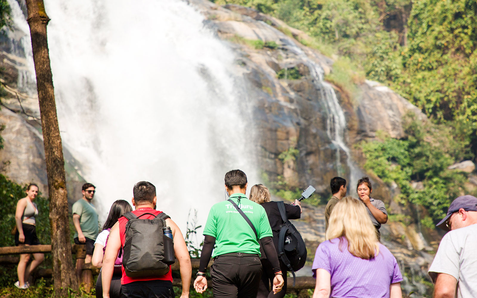 Tour group approaching a large waterfall in Doi Inthanon National Park, Chiang Mai.