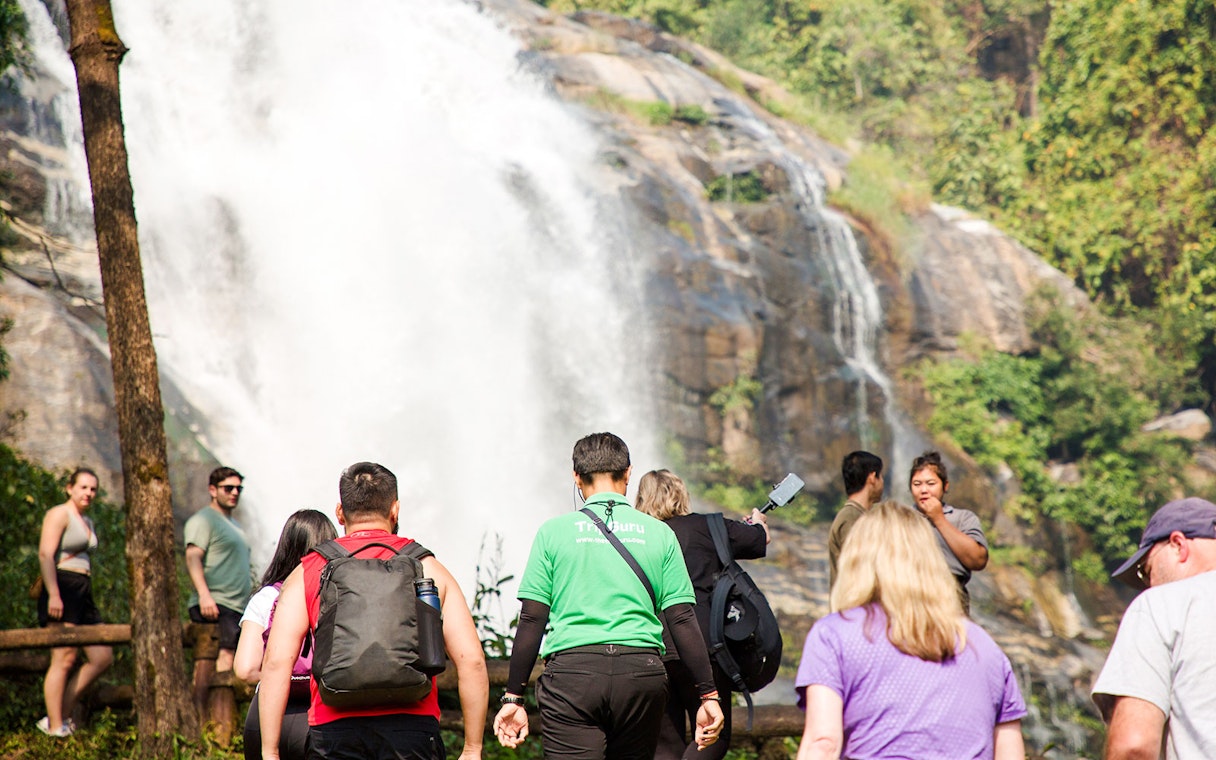 Tour group approaching a large waterfall in Doi Inthanon National Park, Chiang Mai.