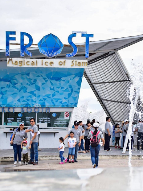 Visitors at Frost Magical Ice of Siam entrance with fountain and statue in Pattaya, Thailand.