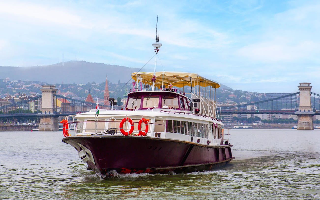 Guests on Budapest Highlights River Cruise with Chain Bridge in background.