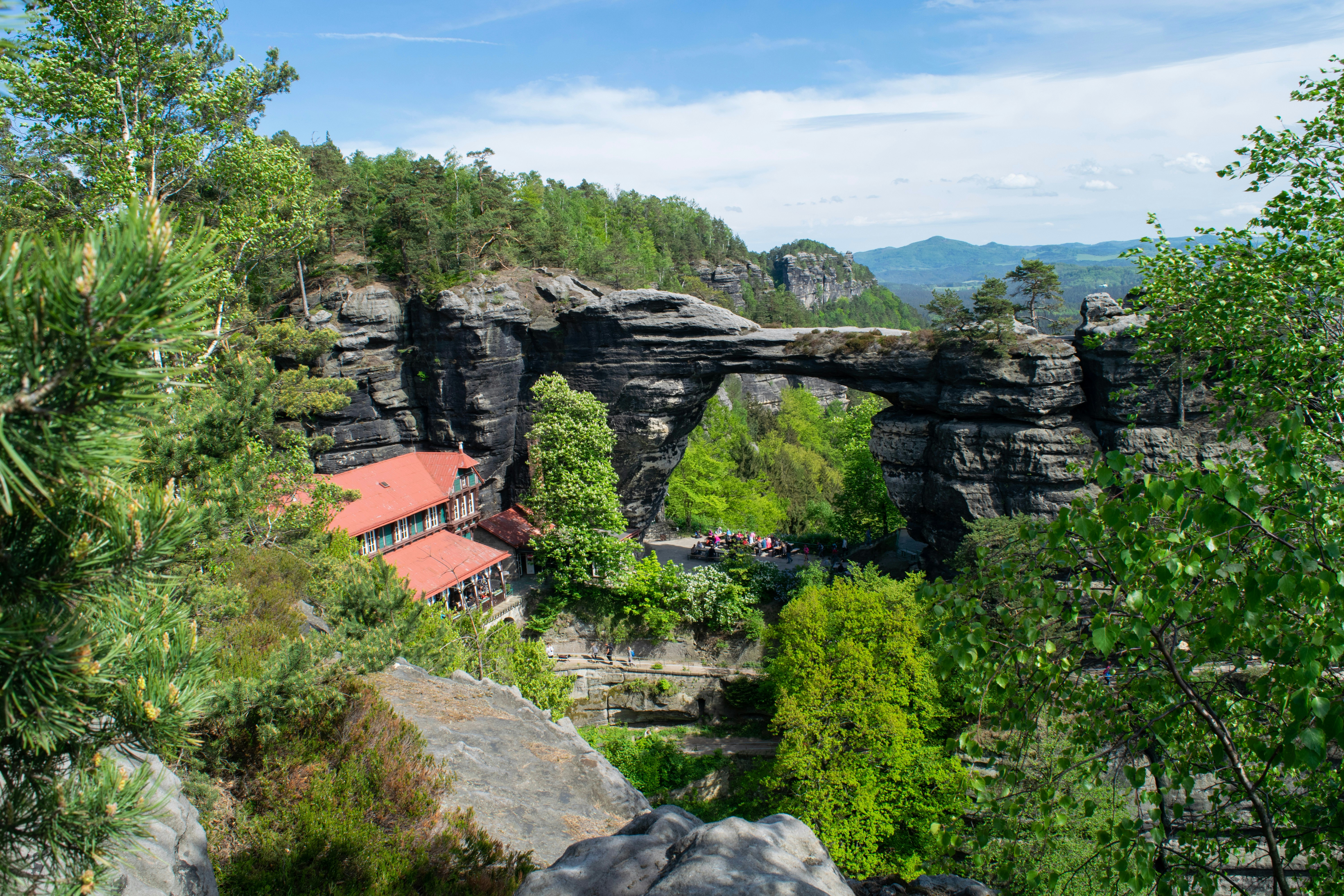 Pravčická Brána rock arch surrounded by lush greenery in Bohemian Switzerland.