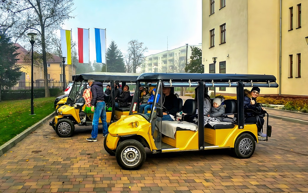 Golf carts with tourists in Krakow's Jewish Quarter, part of Schindler's Factory Museum tour.