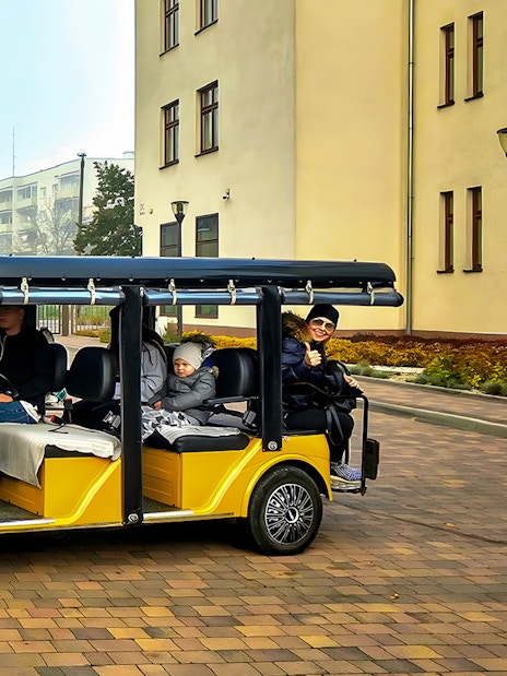 Golf carts with tourists in Krakow's Jewish Quarter, part of Schindler's Factory Museum tour.