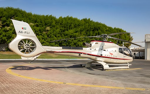 Helicopter on helipad ready for Abu Dhabi aerial tour.