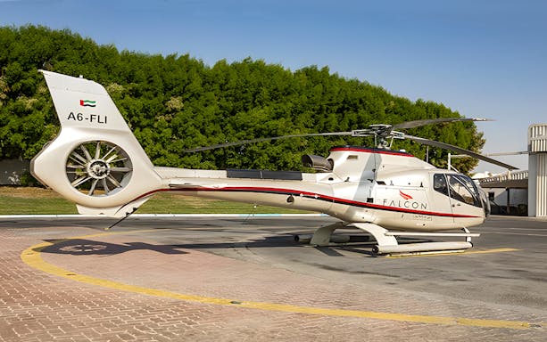 Helicopter on helipad ready for Abu Dhabi aerial tour.