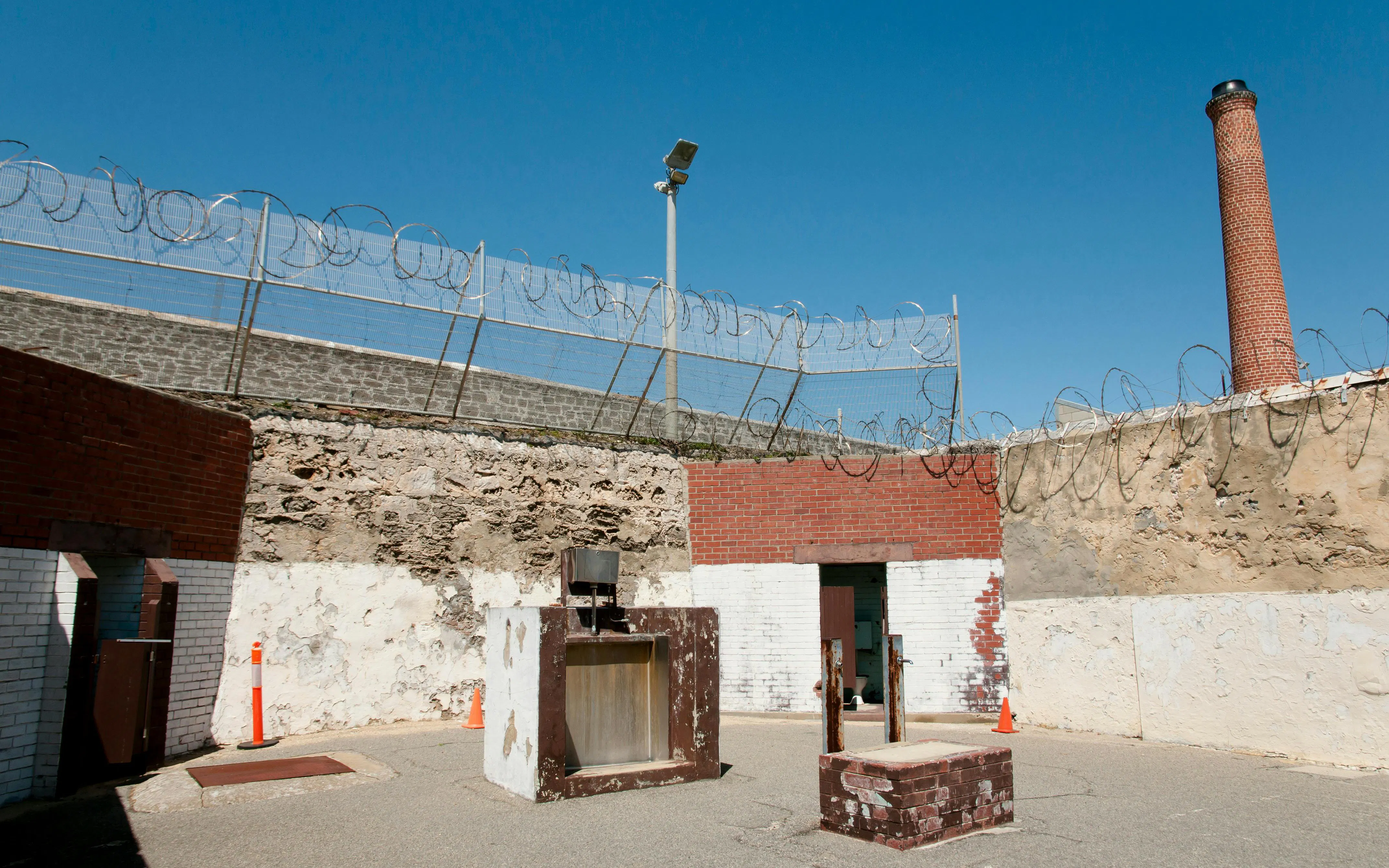 Courtyard with barbed wire and chimney at Fremantle Prison, Australia.