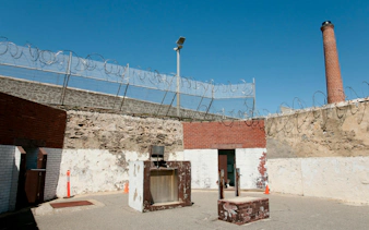 Courtyard with barbed wire and chimney at Fremantle Prison, Australia.