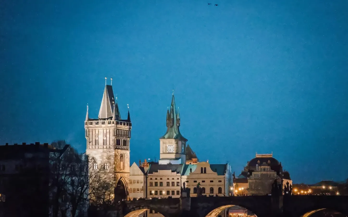 Prague Castle towers illuminated at night during Alchemy & Mysteries tour.