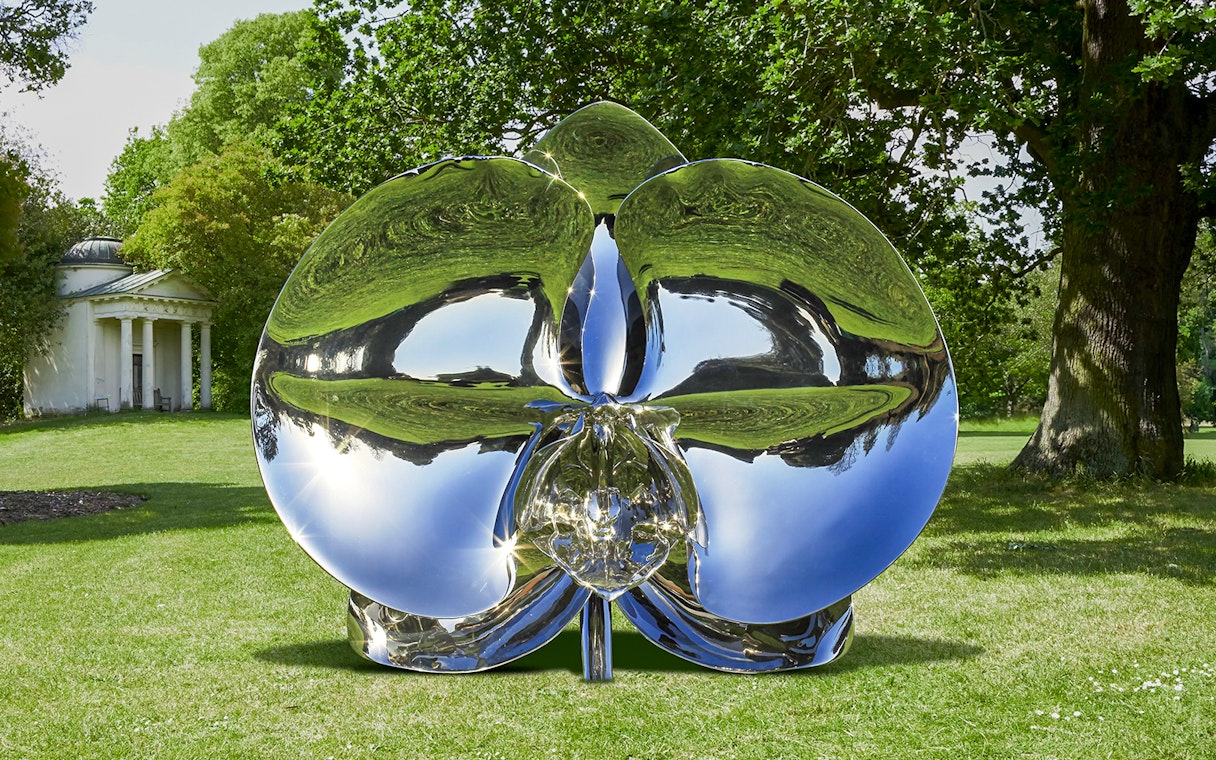 Reflective sculpture "Light of Life" by Marc Quinn in a park setting.