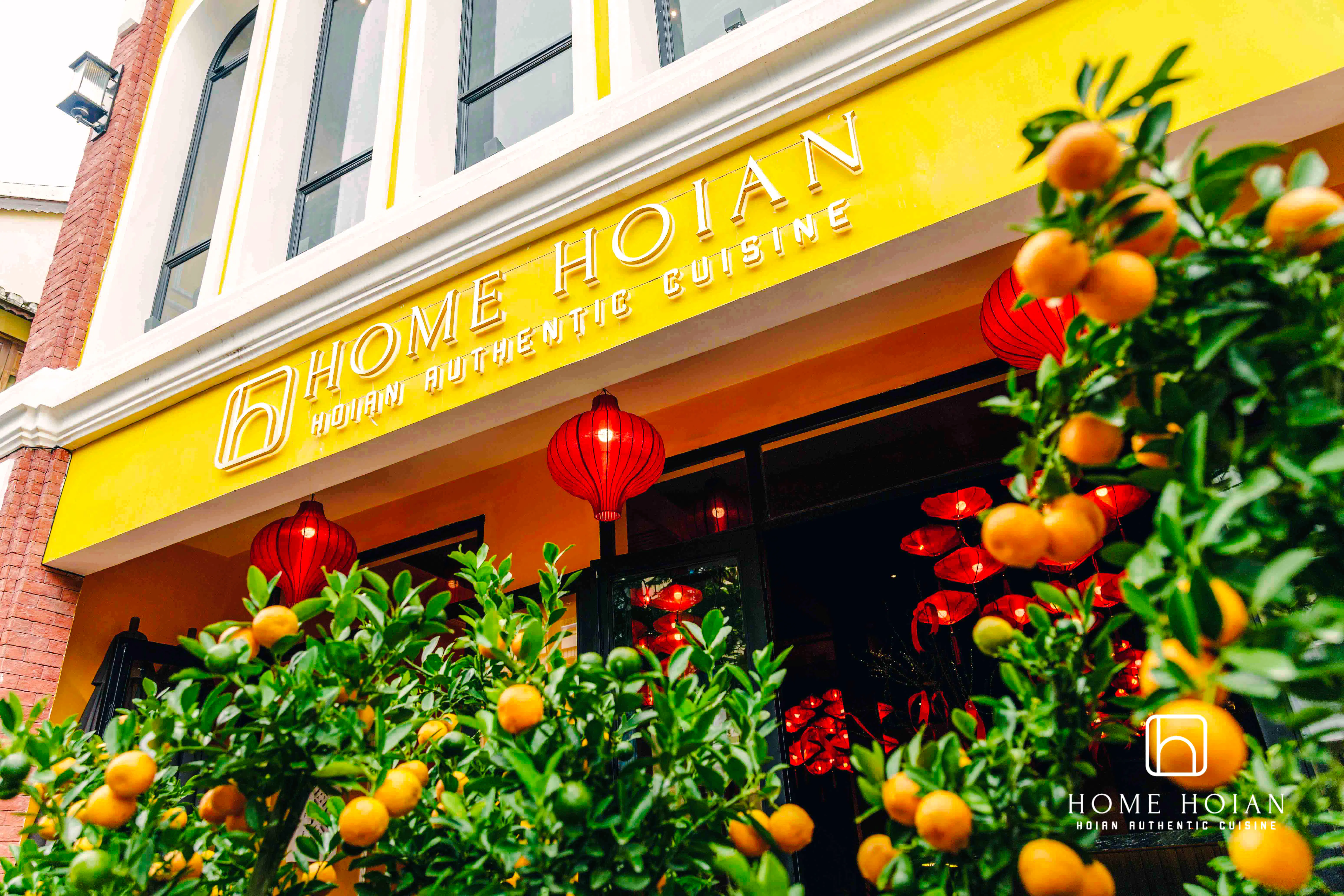 HOME Hoi An Restaurant entrance with red lanterns and citrus plants, Hoi An.