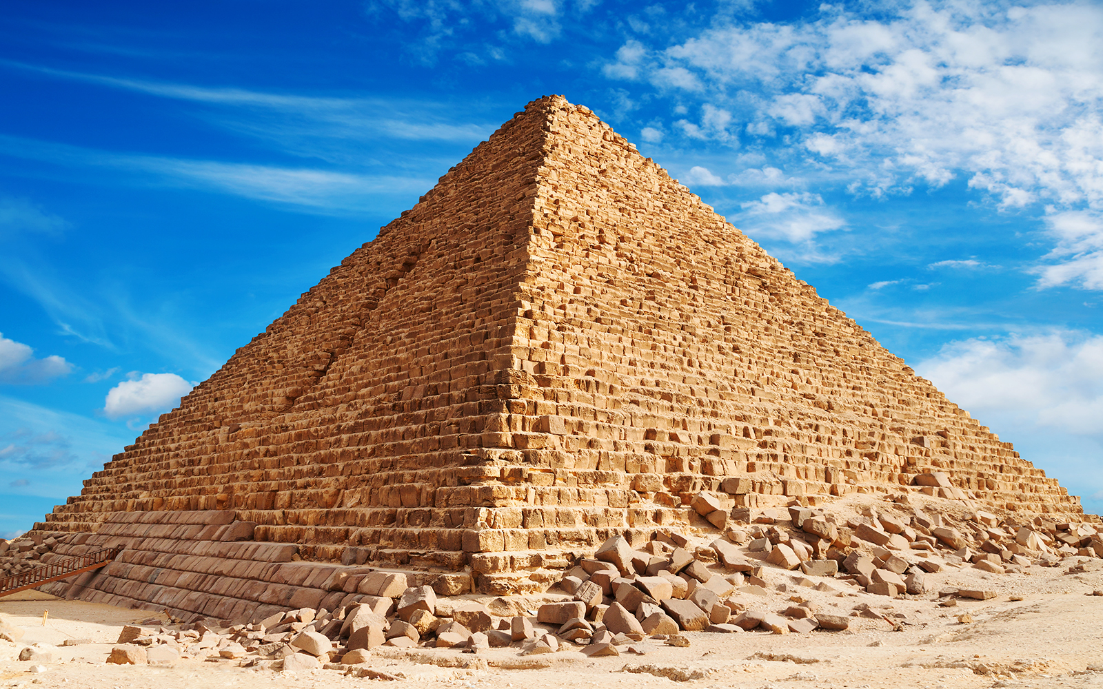 Pyramid of Khufu in Giza under a clear blue sky.