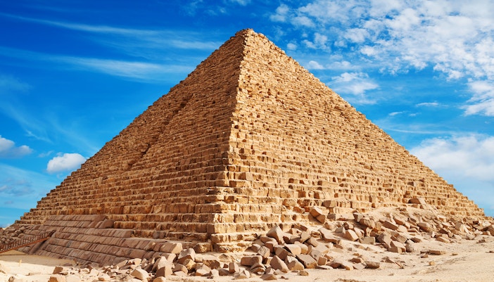 Pyramid of Khufu in Giza under a clear blue sky.