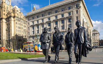 Statues of famous musicians in front of the Royal Liver Building, Liverpool.