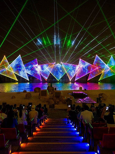 Tourists watching the Wings of Time light and sound show at Sentosa Island, Singapore.