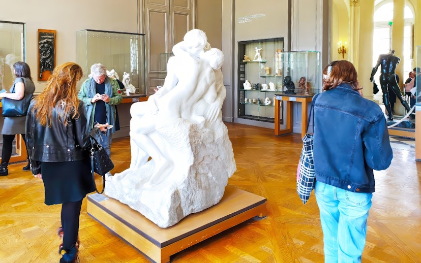 Tourists viewing The Kiss sculpture at the Rodin Museum in Paris.