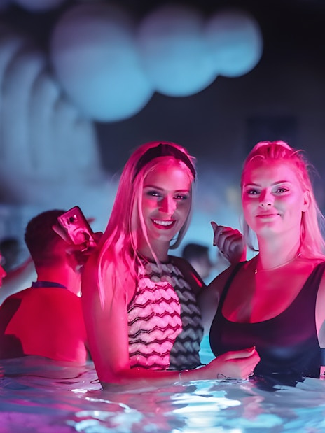 People enjoying Sparty bath party in Budapest thermal pool.