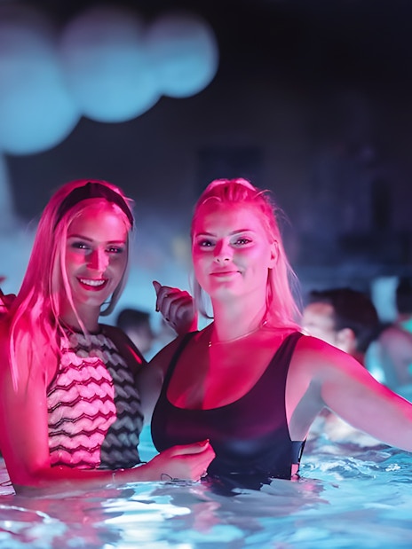 People enjoying Sparty bath party in Budapest thermal pool.