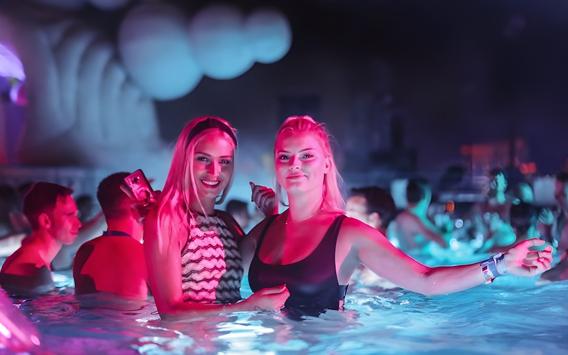 People enjoying Sparty bath party in Budapest thermal pool.