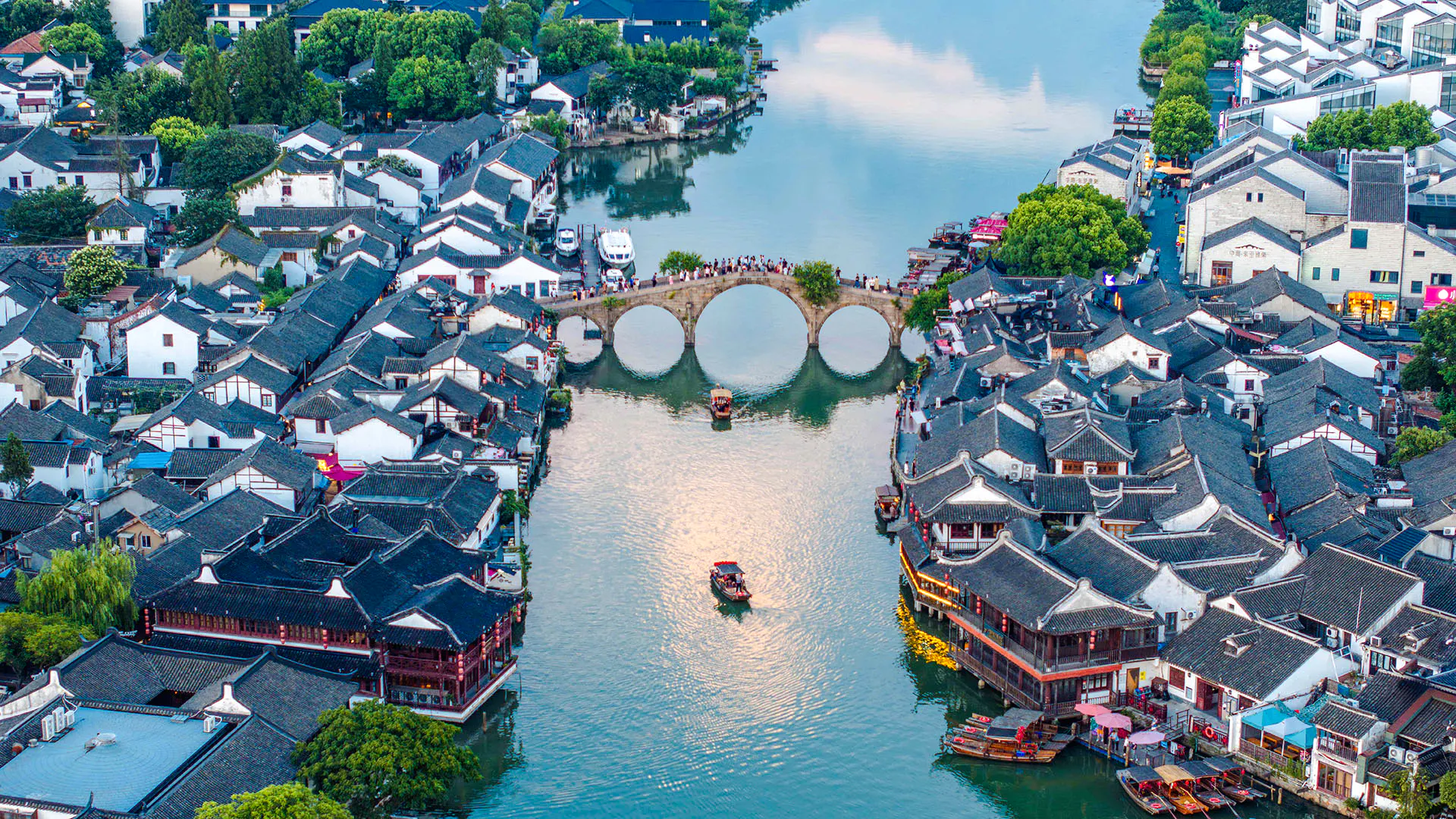 Zhujiajiao water town with arched bridge and traditional buildings, Shanghai day tour.