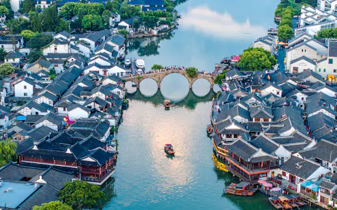 Zhujiajiao water town with arched bridge and traditional buildings, Shanghai day tour.