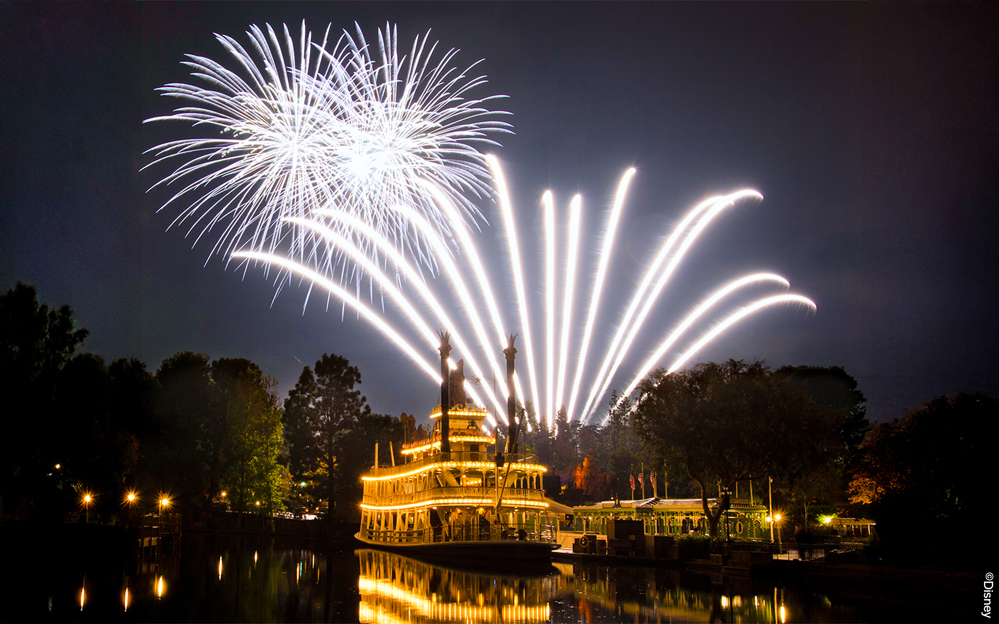Fireworks over a riverboat at Disneyland Park, California.