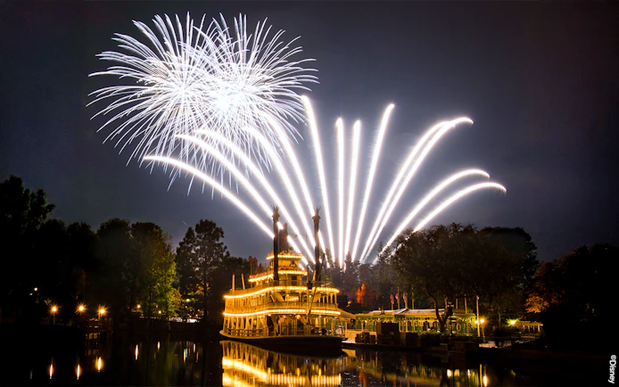 Fireworks over a riverboat at Disneyland Park, California.
