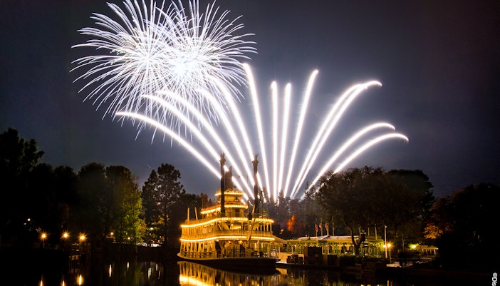 Fireworks over a riverboat at Disneyland Park, California.