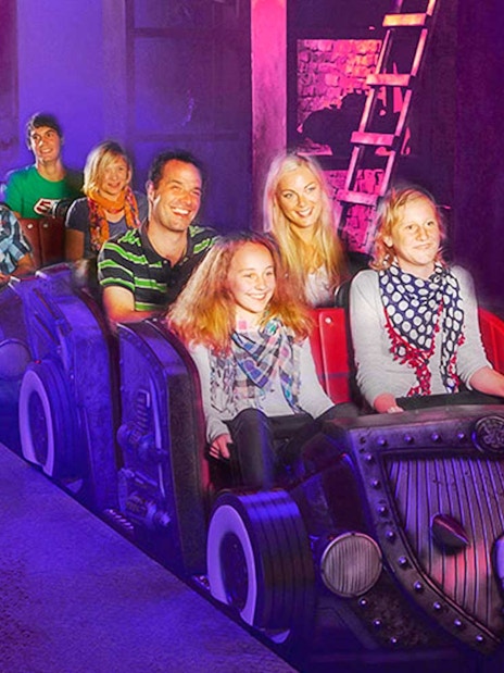 Visitors on a themed ride at Van Helsing's Factory, Movie Park.