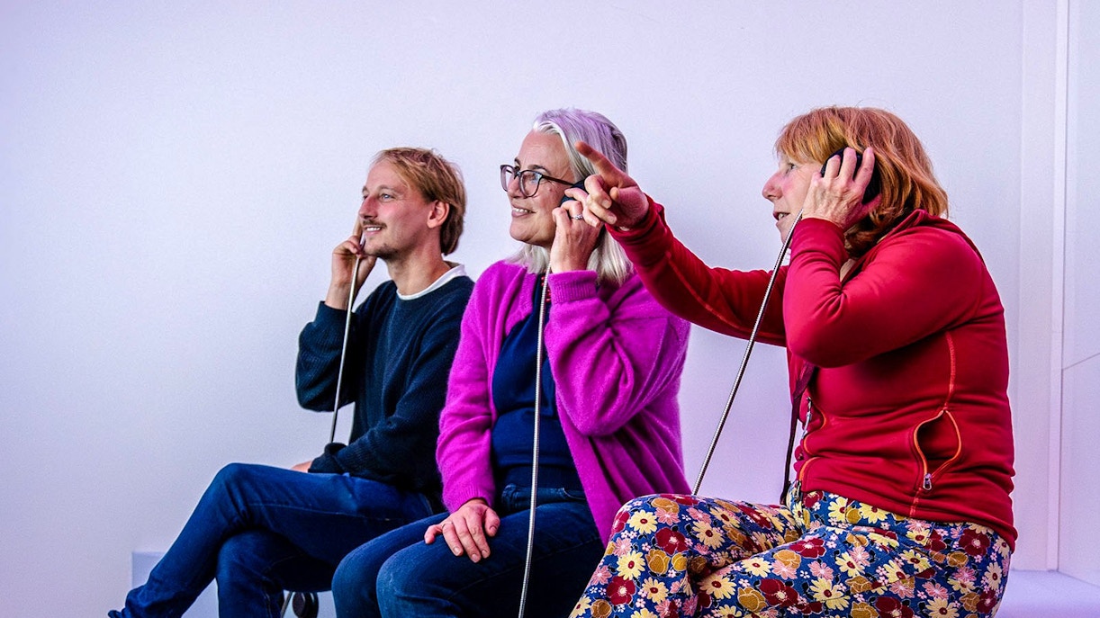 Visitors listening to audio at Amsterdam in Motion exhibit.