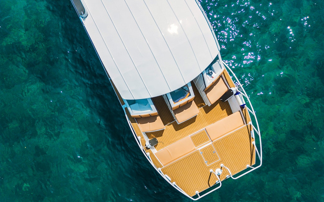 Aerial view of Premium Speed Catamaran deck on clear blue water.