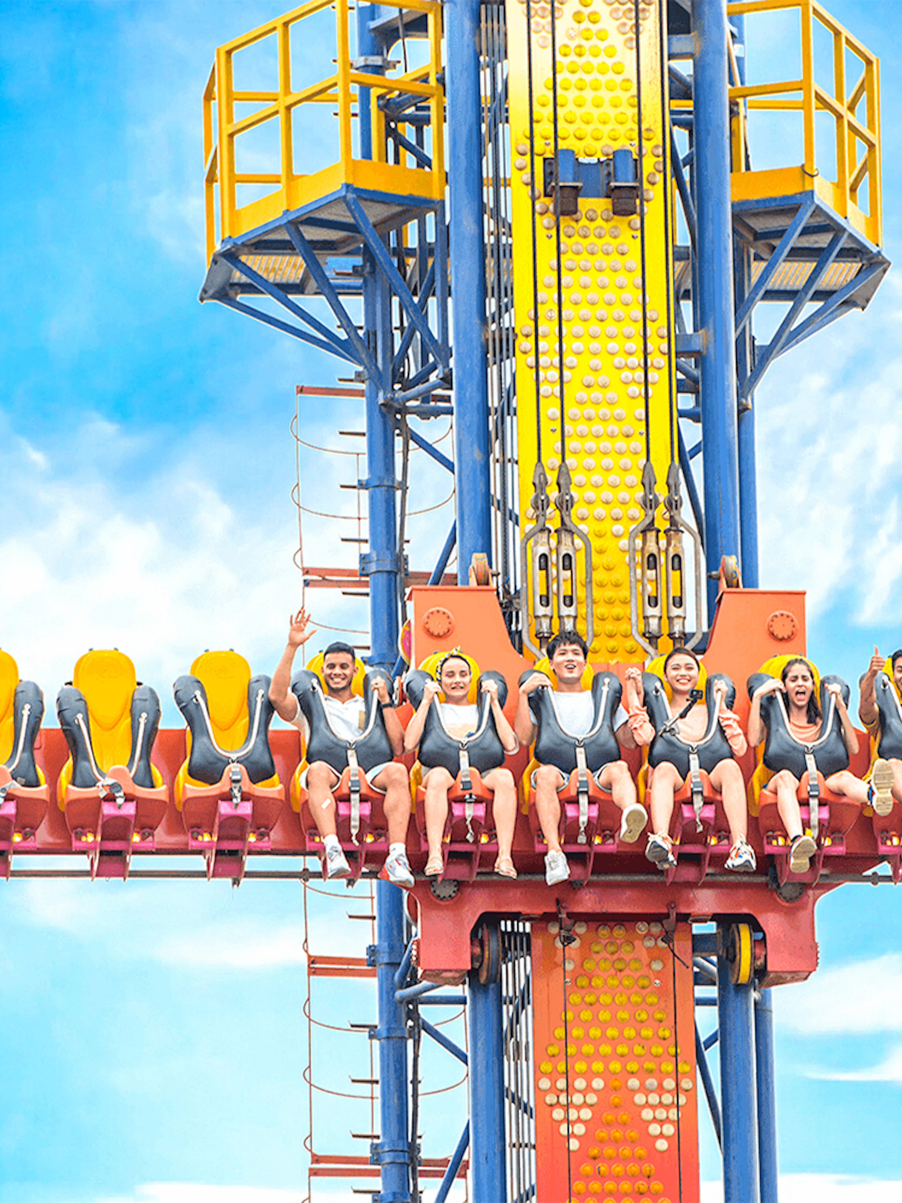 Sky fall ride at VinWonders Nha Trang with people seated, ready for the drop.