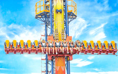 Sky fall ride at VinWonders Nha Trang with people seated, ready for the drop.