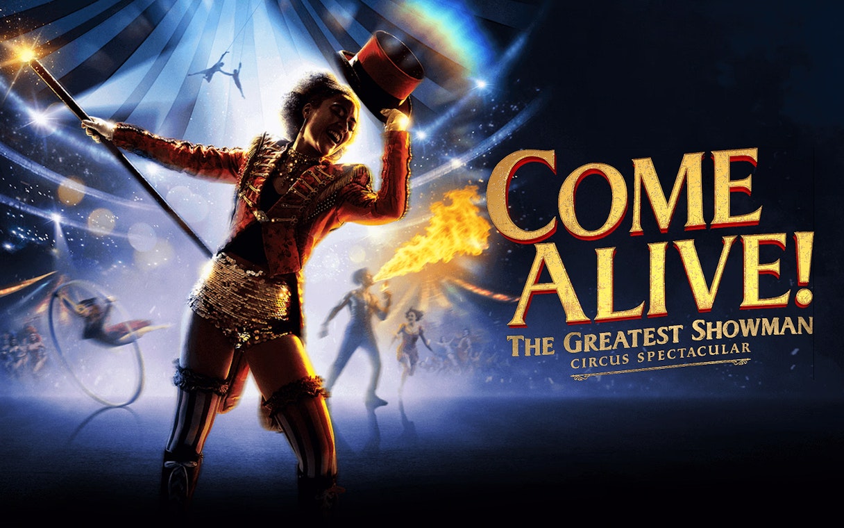 Circus performer with top hat and baton in vibrant show, "Come Alive" theme.