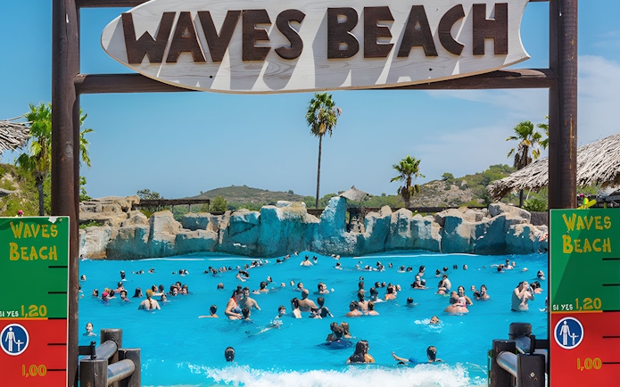 Visitors enjoying the wave pool at Waves Beach in Aquopolis Cullera.