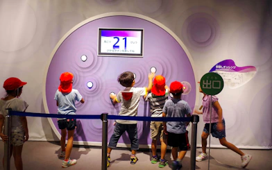 Children interacting with an exhibit at Okinawa Zoo & Museum.