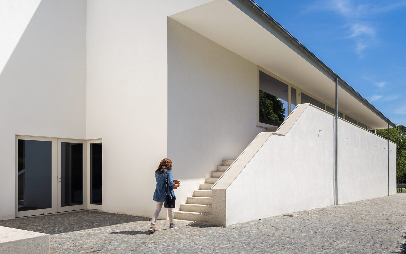 Visitor approaching modern architecture at Serralves, Porto.