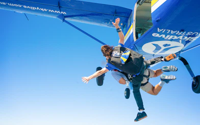 Tandem skydivers jumping from plane over Newcastle.