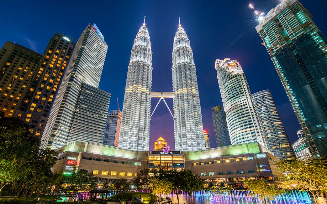 Petronas Twin Towers illuminated at night in Kuala Lumpur, near Petrosains Discovery Centre.