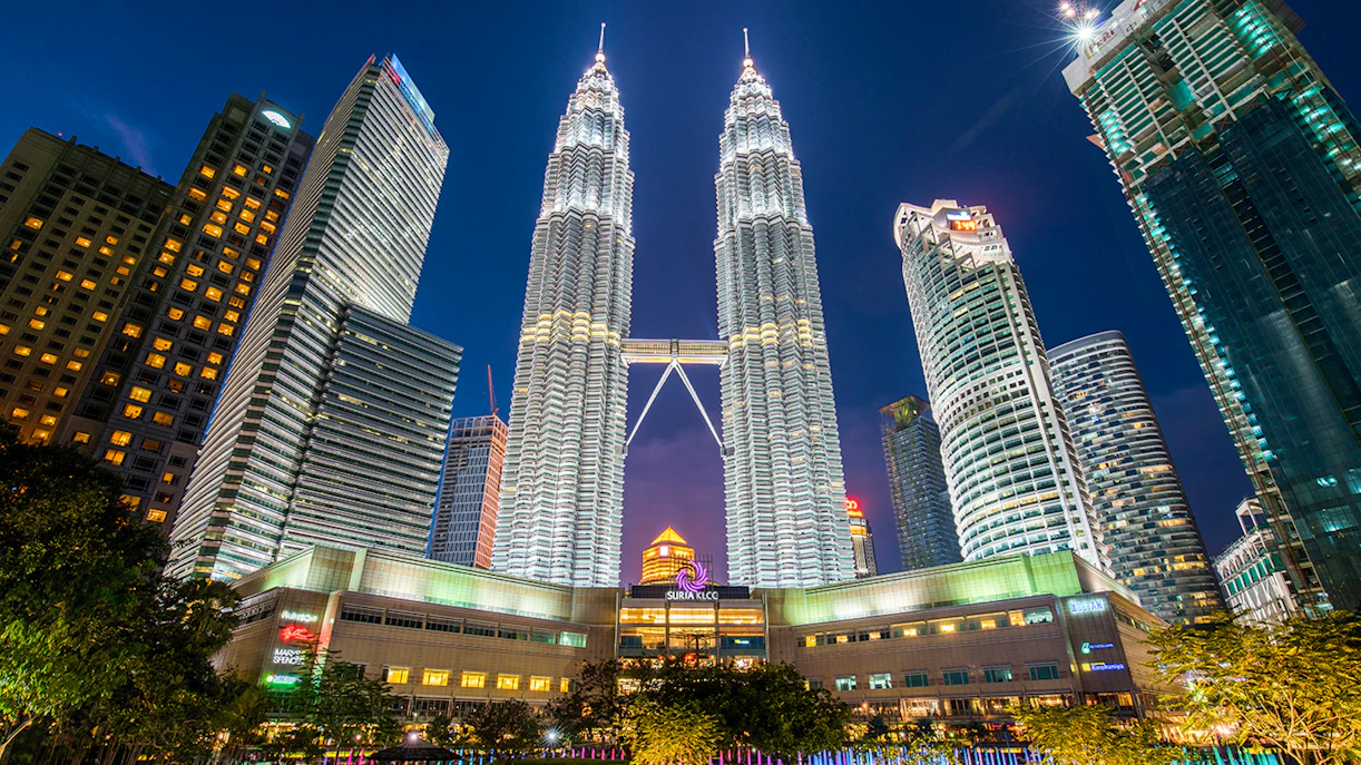 Petronas Twin Towers illuminated at night in Kuala Lumpur, near Petrosains Discovery Centre.