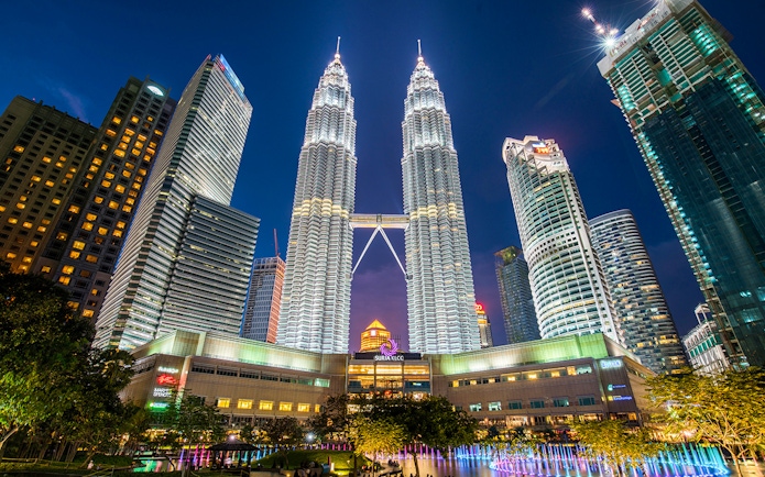 Petronas Twin Towers illuminated at night in Kuala Lumpur, near Petrosains Discovery Centre.