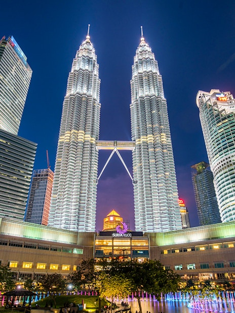 Petronas Twin Towers illuminated at night in Kuala Lumpur, near Petrosains Discovery Centre.