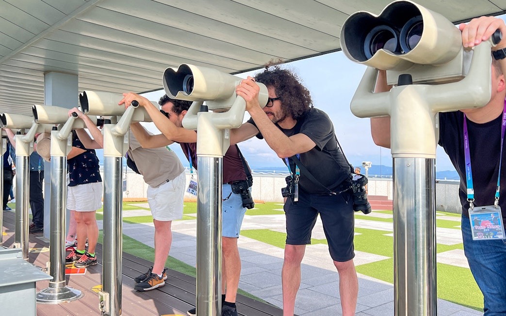 Visitors using binoculars at the DMZ observatory in Korea.